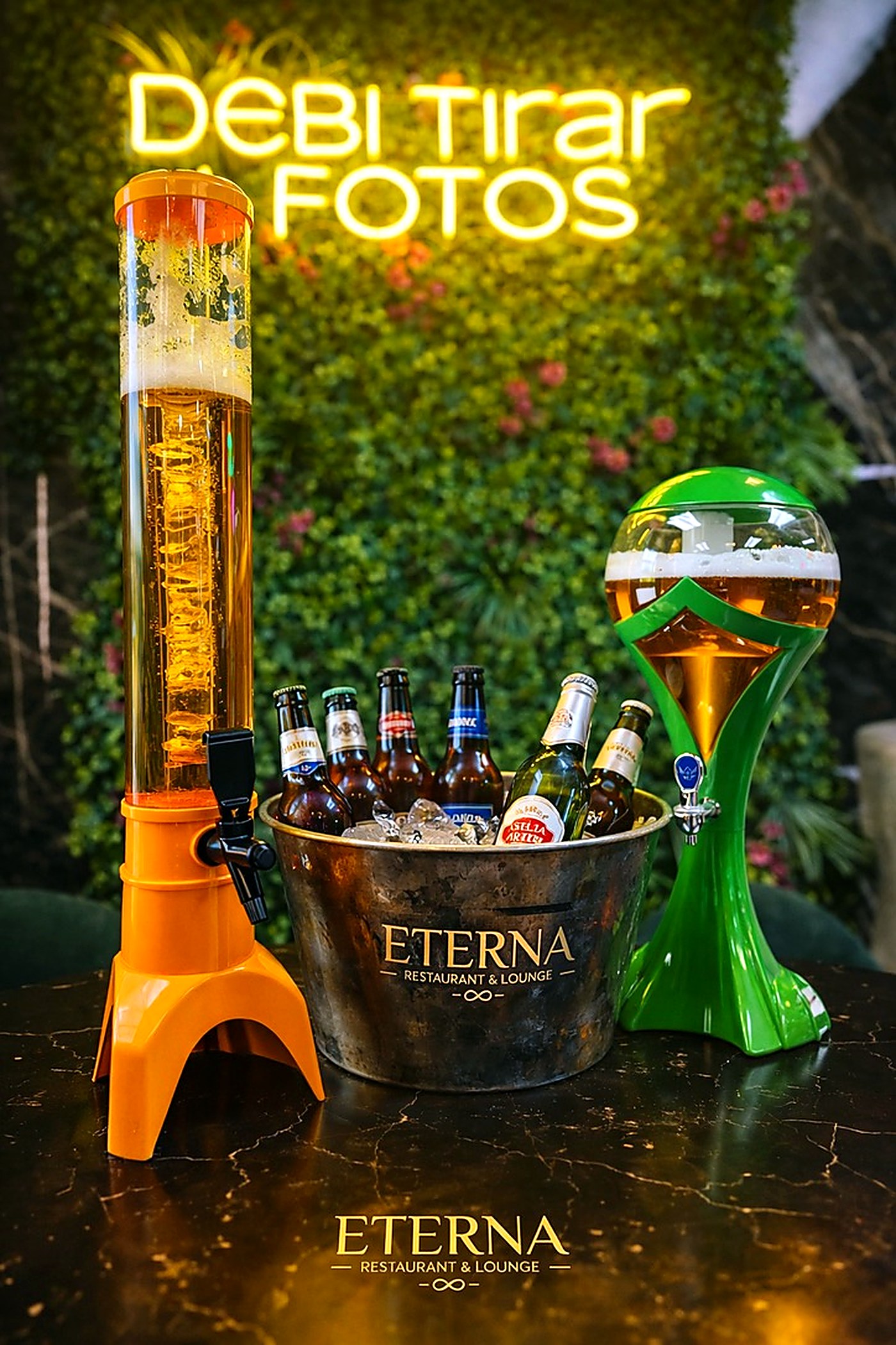 Beer towers with an iced Eterna bucket of bottled beer under the neon sign