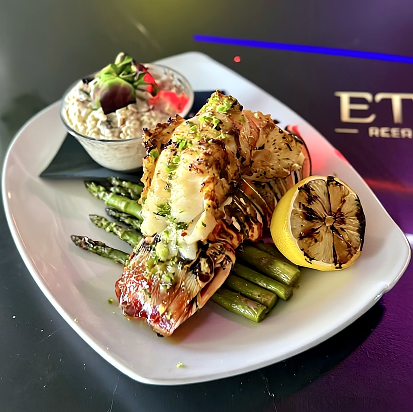 Grilled lobster tail with asparagus, remoulade and charred lemon at Eterna
