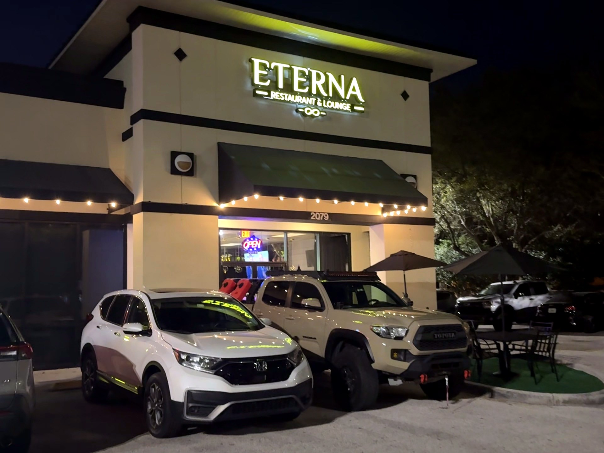 Eterna Restaurant & Lounge storefront lit up at night on E Osceola Pkwy Kissimmee